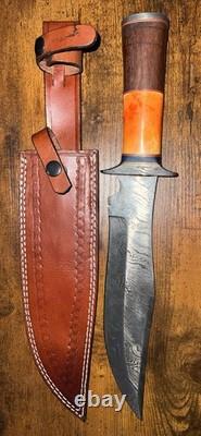 Damascus Steel Hunting Knife with Ornate Handle and Leather Sheath